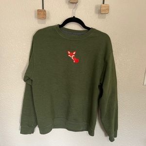 Olive green sweatshirt with an orange fox decal